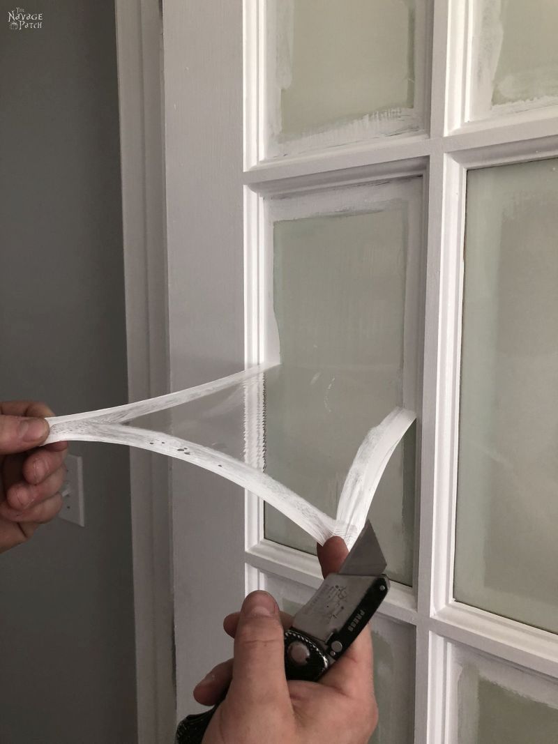 peeling masking liquid from a french door