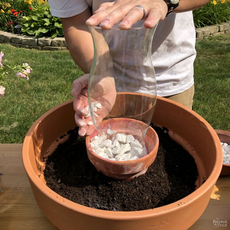 putting a hurricane glass in a clay pot