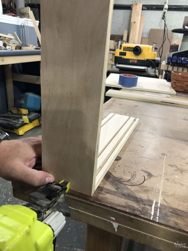 brad nailing pieces for a diy craft paint storage rack