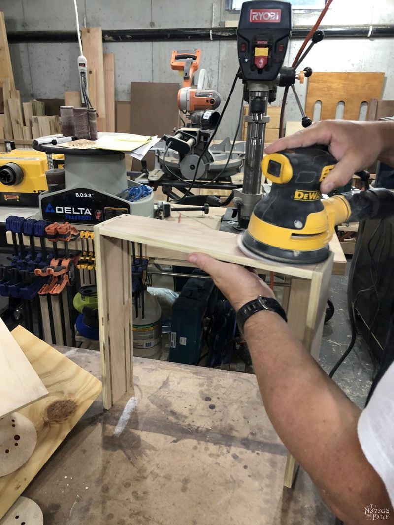 sanding a diy craft paint storage rack