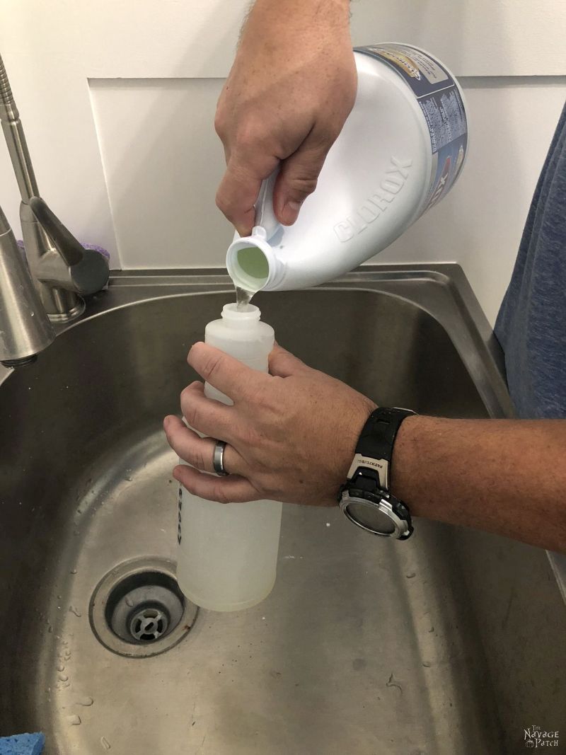 pouring bleach into a spray bottle