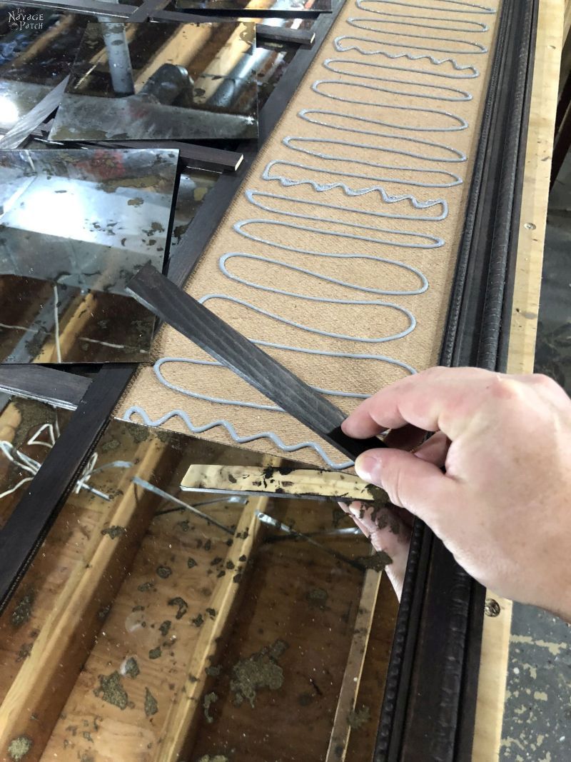 laying panel mirrors in place for a diy antiqued mirror