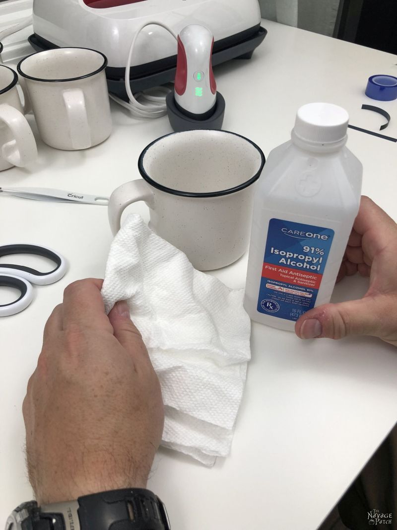 cleaning a mug with rubbing alcohol