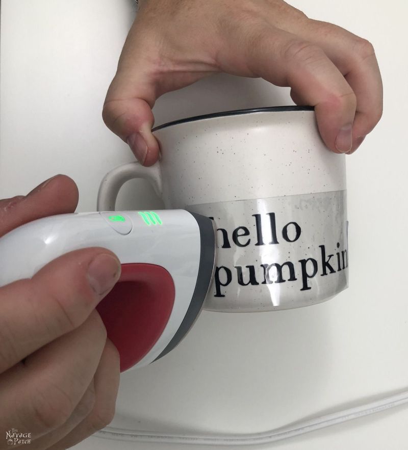 using a cricut easypress mini to transfer a design onto a mug