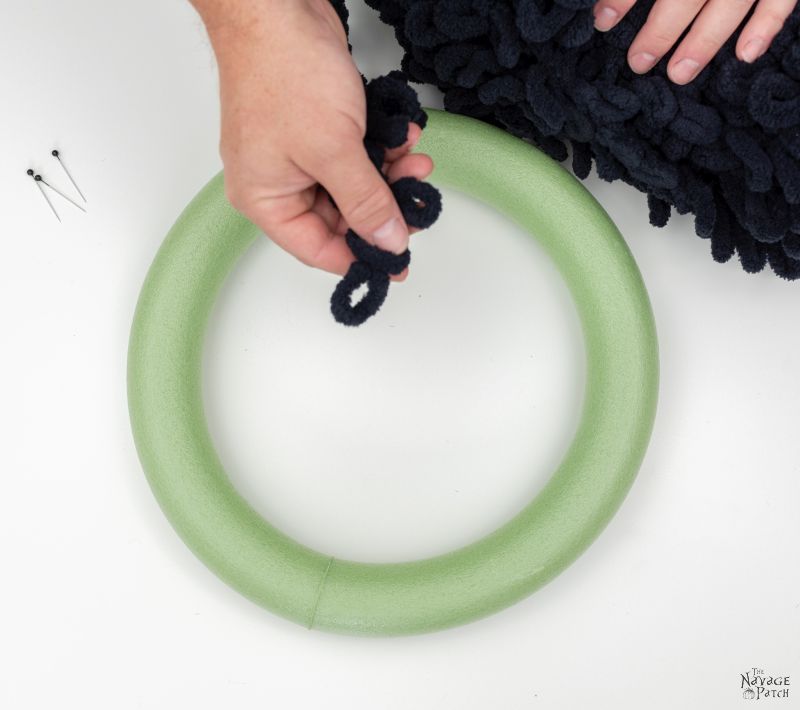 holding loop yarn over a wreath form