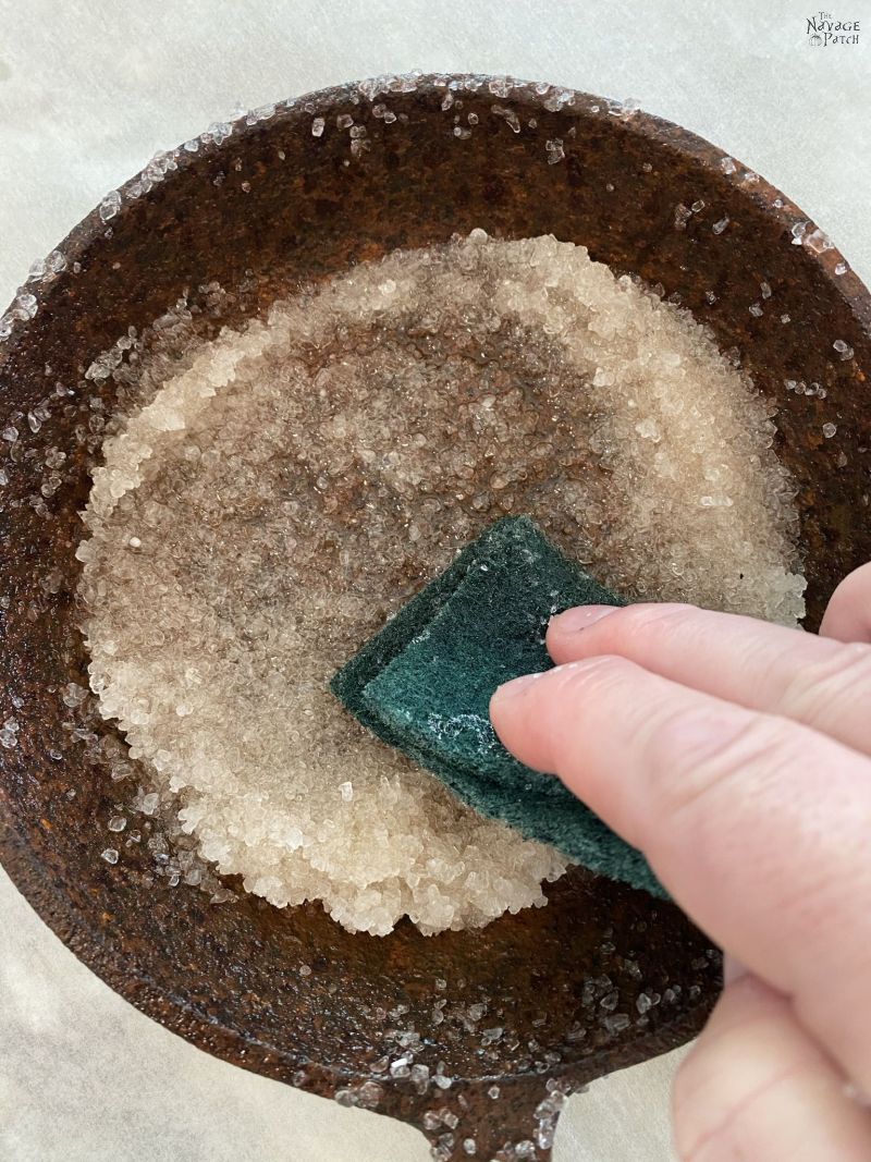 cleaning a rusty cast iron pan with salt