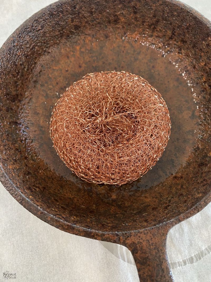 scrubbing rust from a cast iron pan