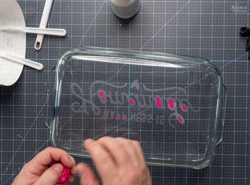 peeling a stencil from an etched baking dish