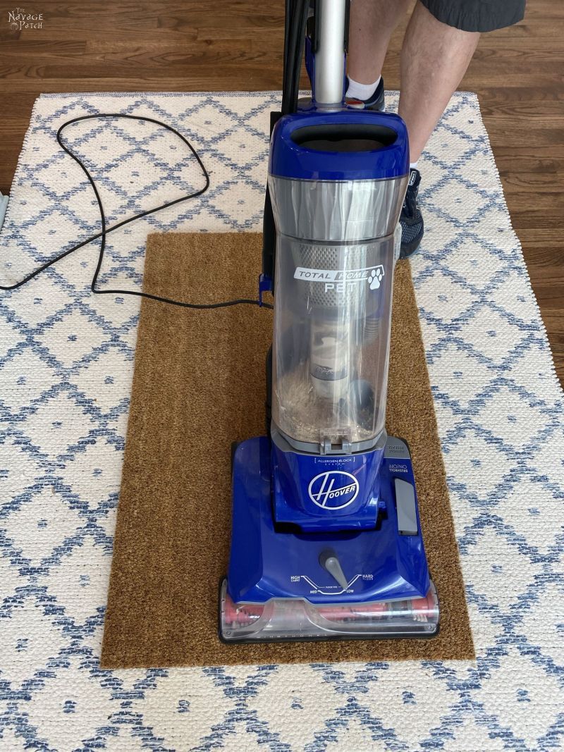 vacuuming a coir mat