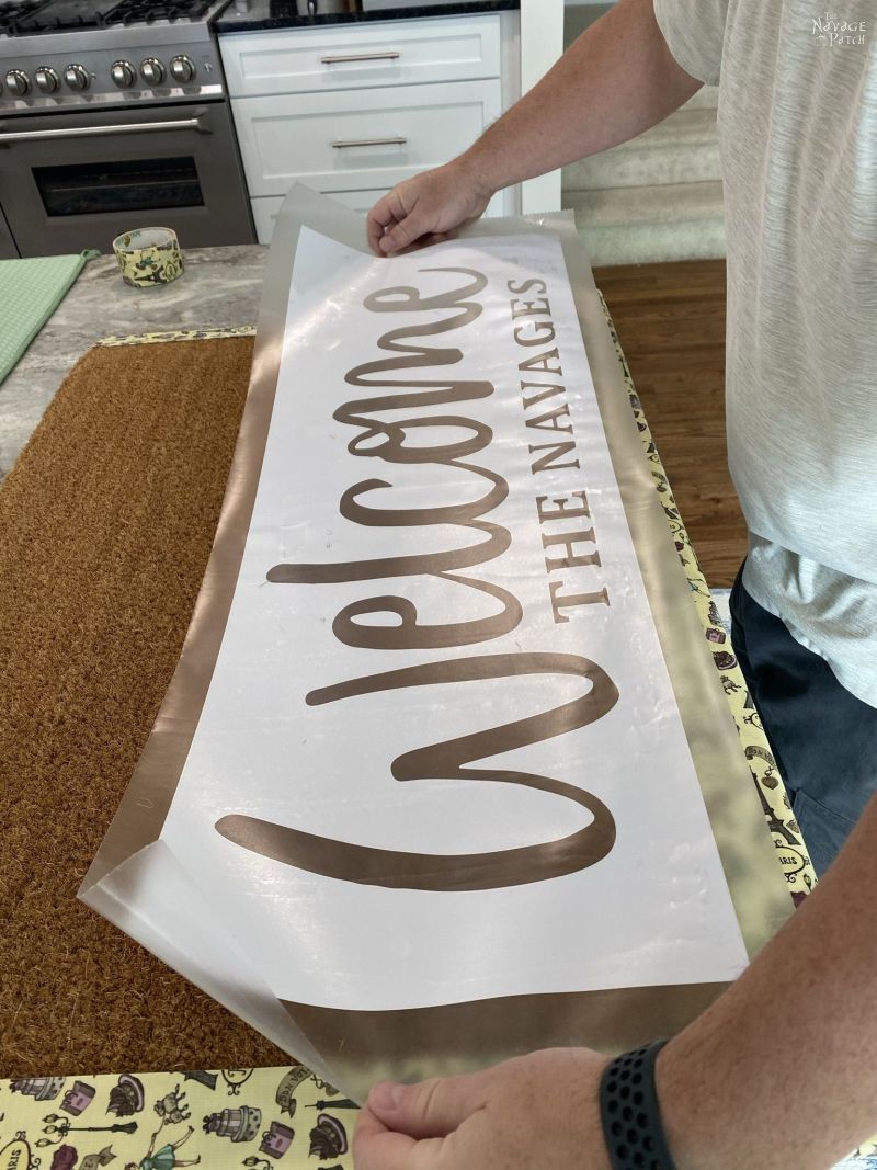 placing a stencil on a door mat