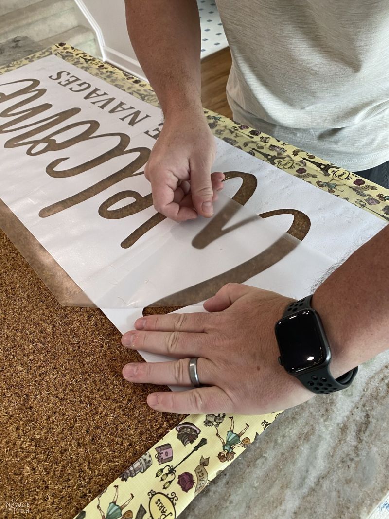 placing a stencil on a door mat