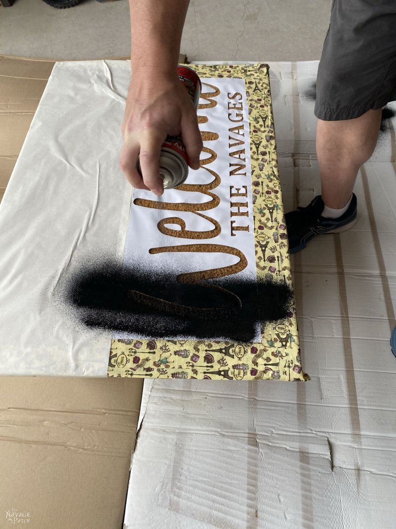 spraying flex seal on a door mat