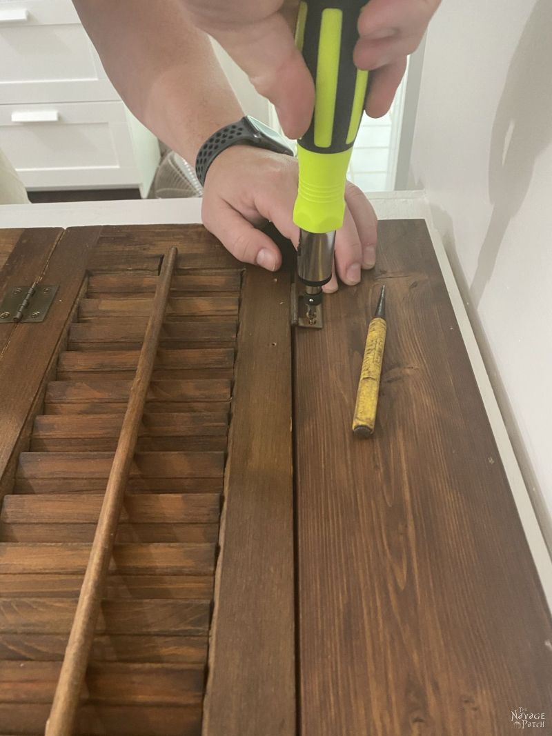 installing a repurposed plantation shutter laundry chute lid