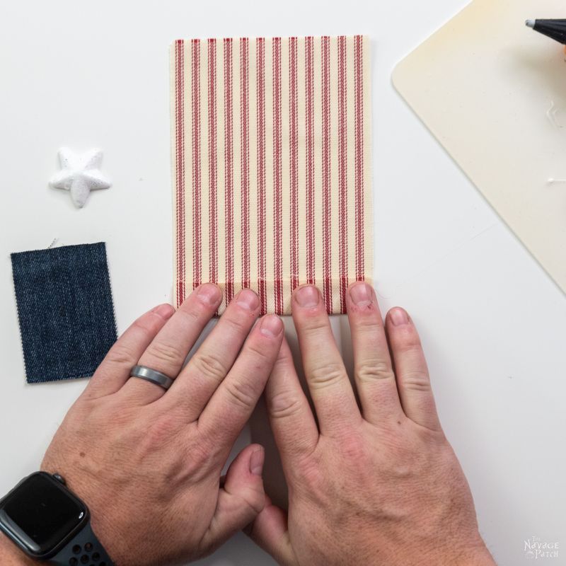 gluing fabric to make a flag garland