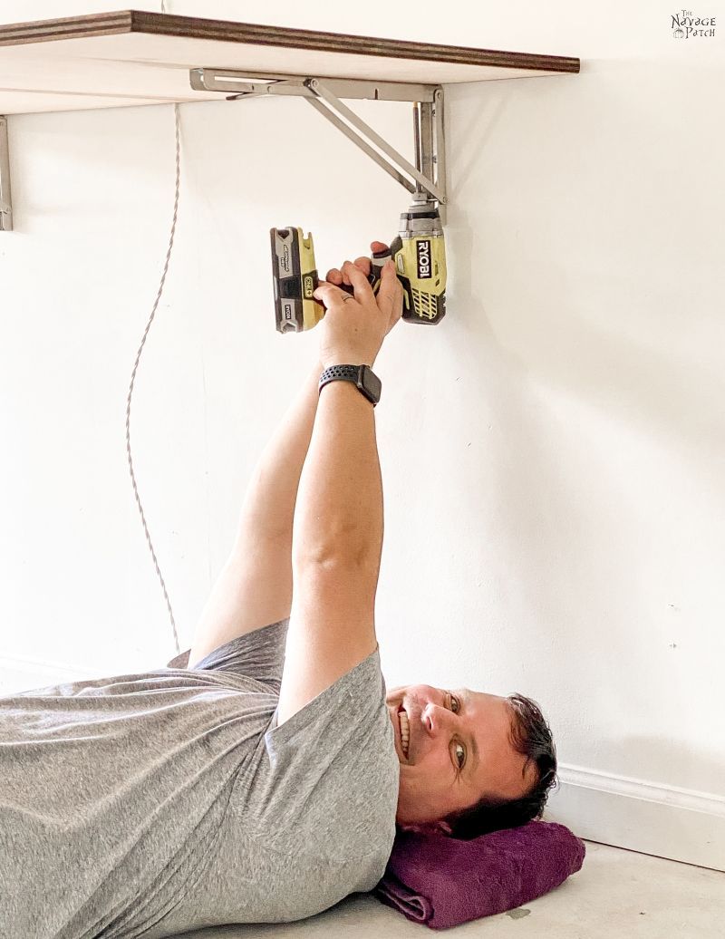 man attaching a table to a folding bracket