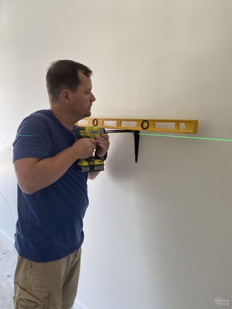 installing brackets to a garage wall with a laser level