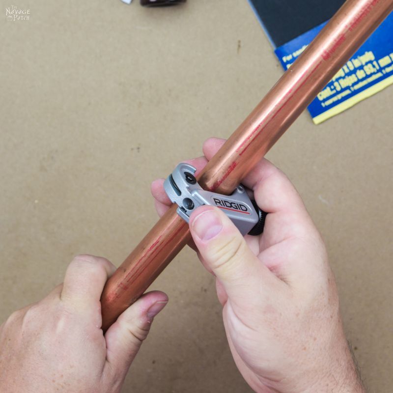 cutting a copper pipe with a tubing cutter