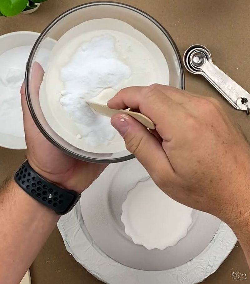 man mixing baking soda into a bowl of paint
