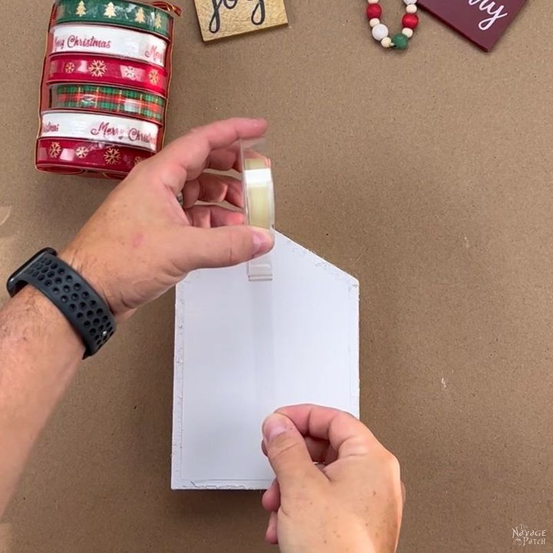 man putting double-sided tape on the backing