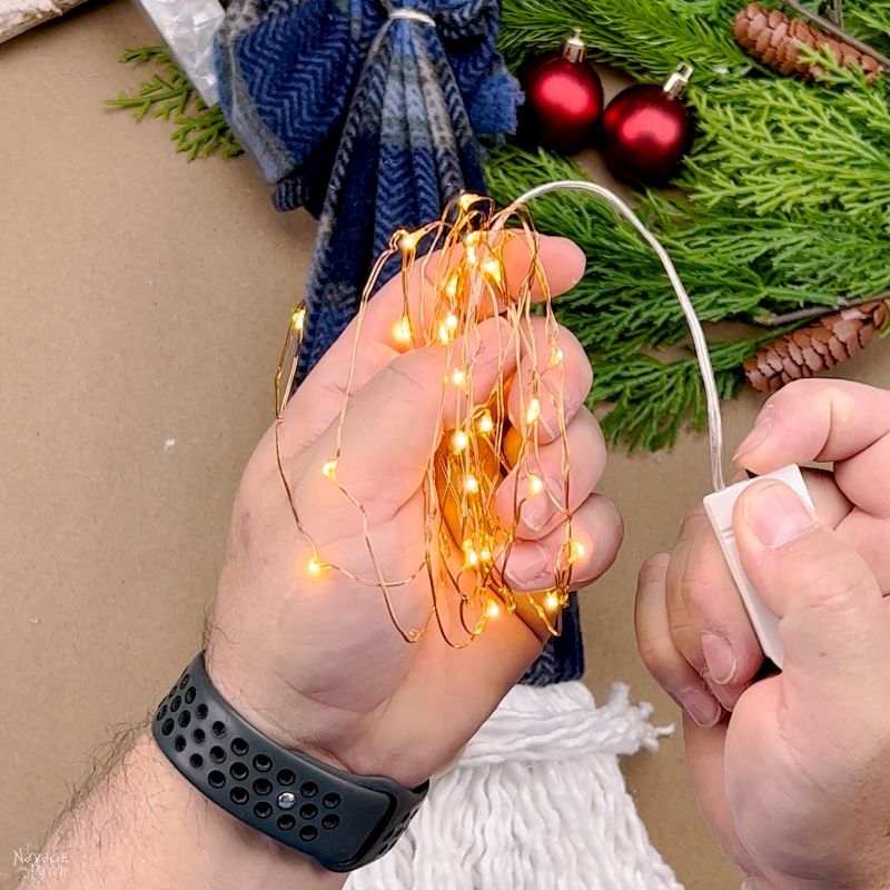 man holding fairy lights