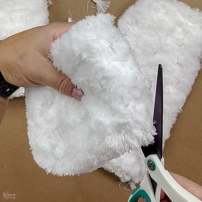 man cutting a dust mop head in half