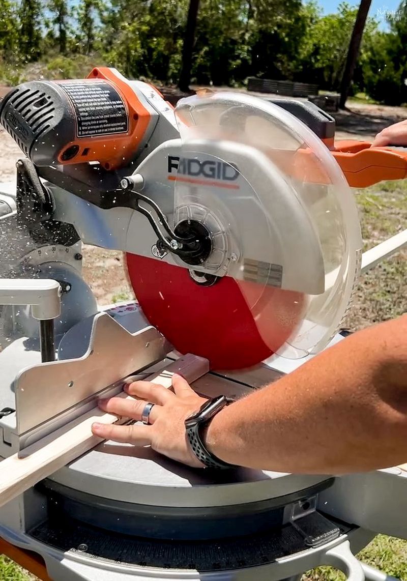 man cutting furring strips with miter saw