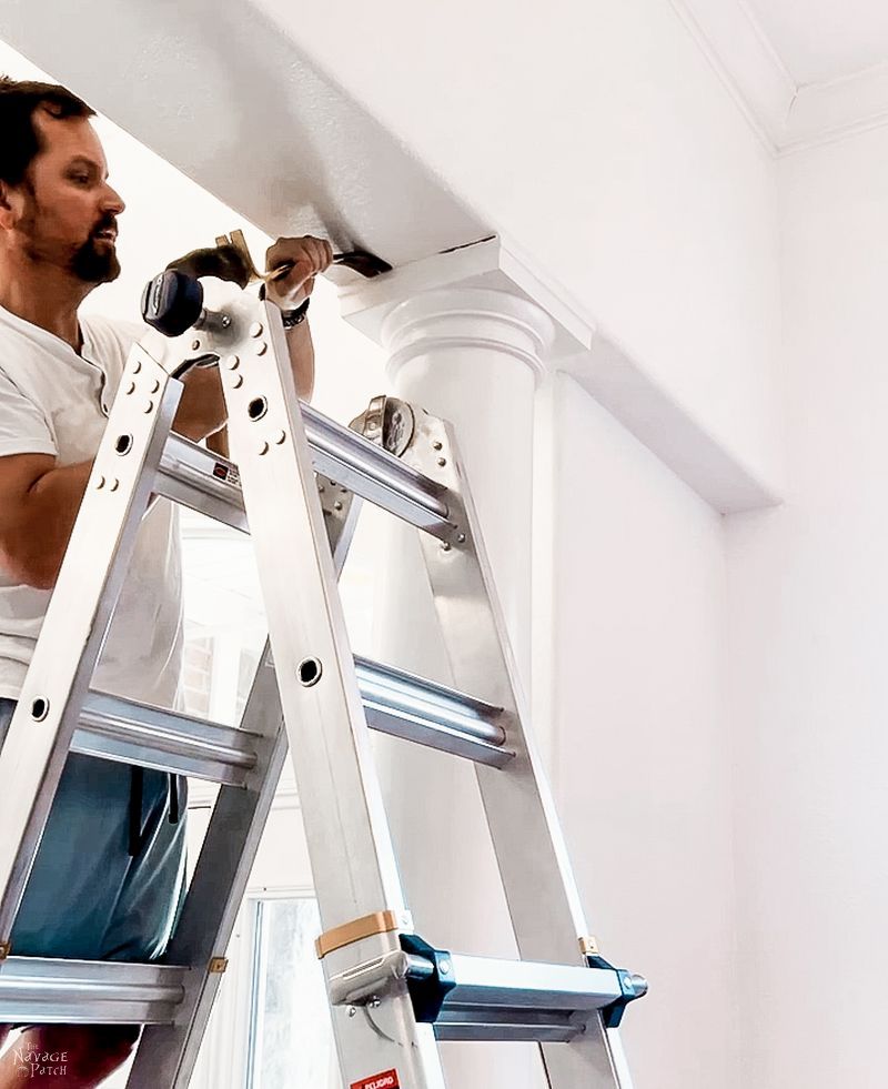 man trying to remove a column in a dining room