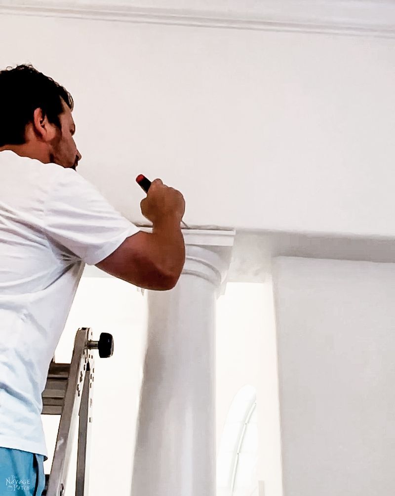 man trying to remove a column in a dining room