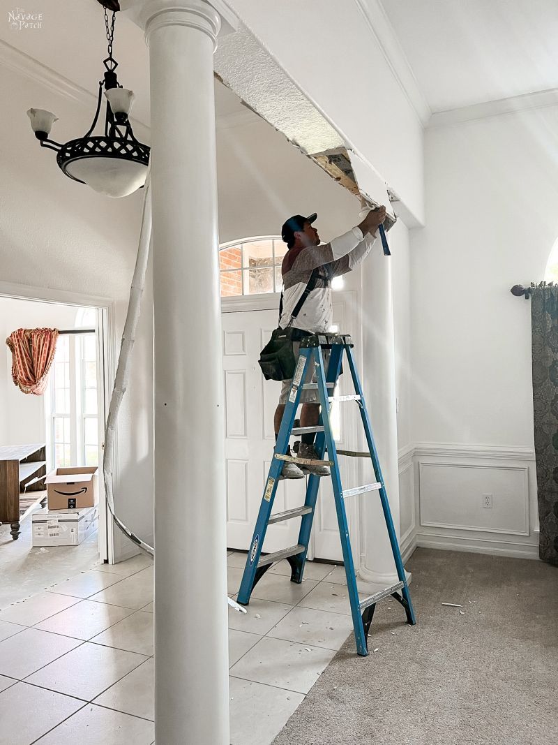 man trying to remove a column in a dining room