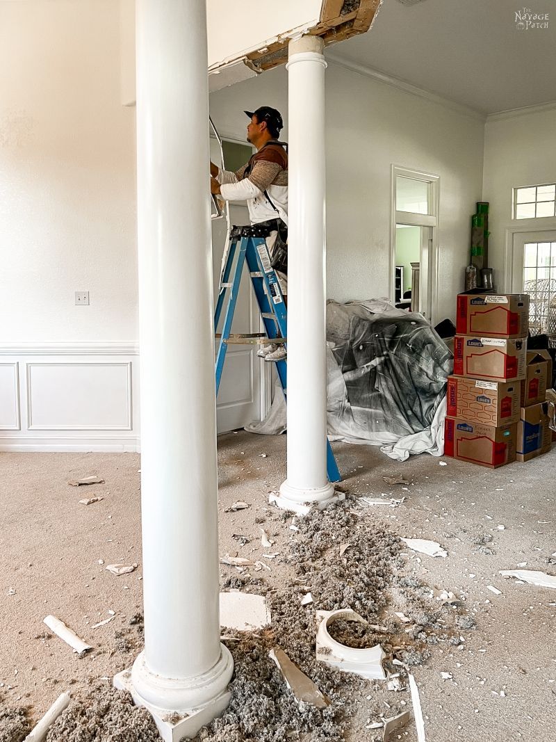 man trying to remove a column in a dining room