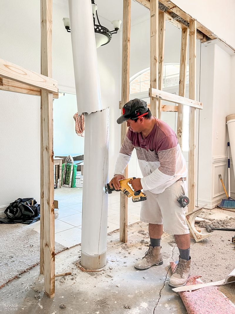 man removing architectural columns from a dining room