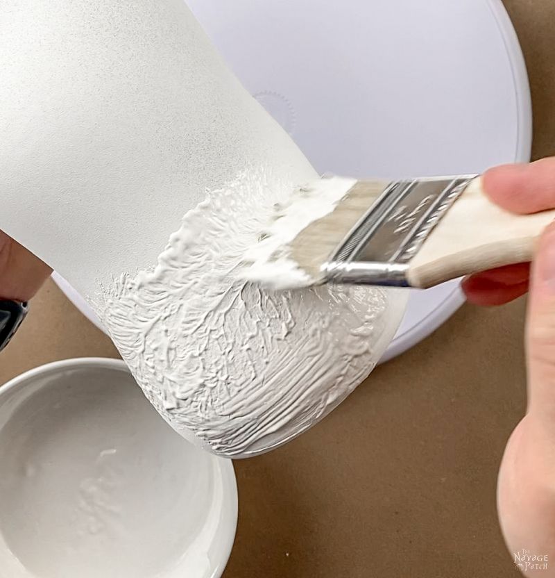 painting a vase with textured paint.