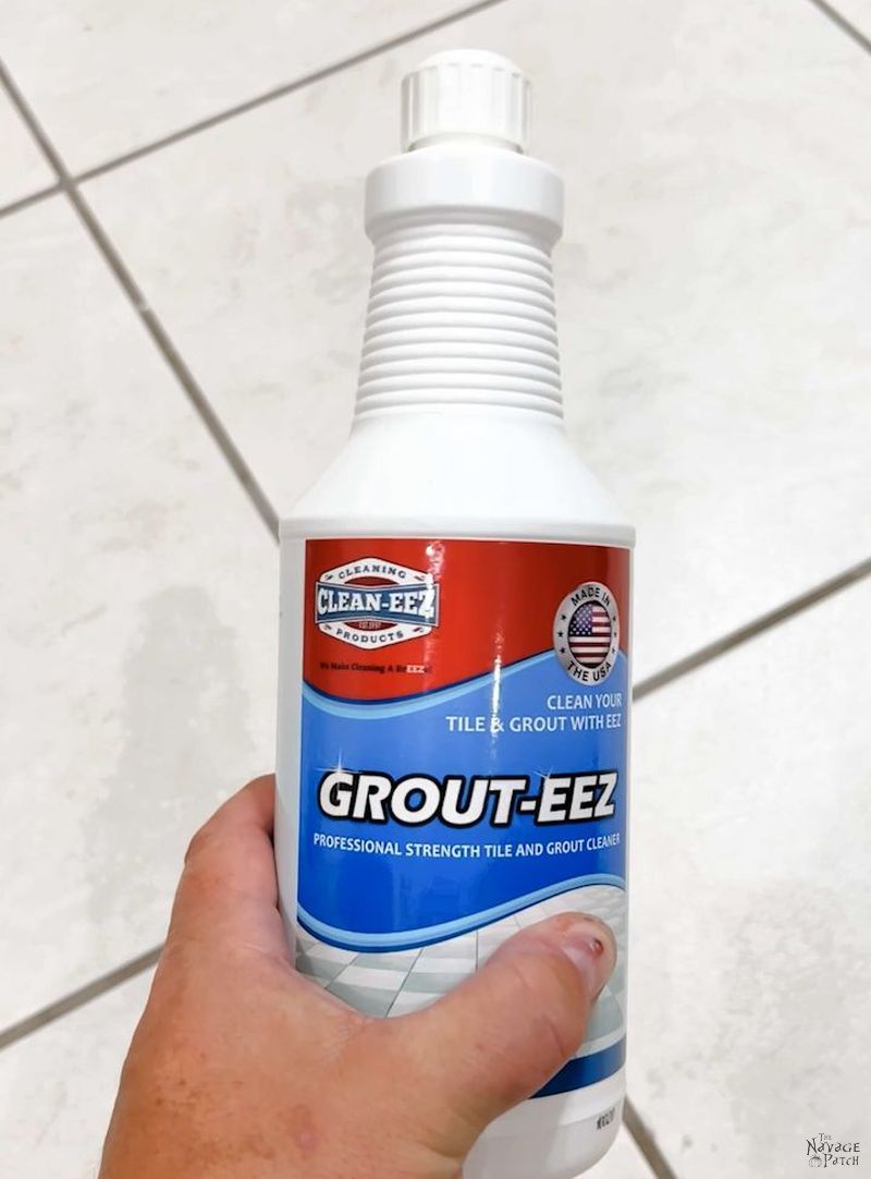 man holding a bottle of grout cleaner