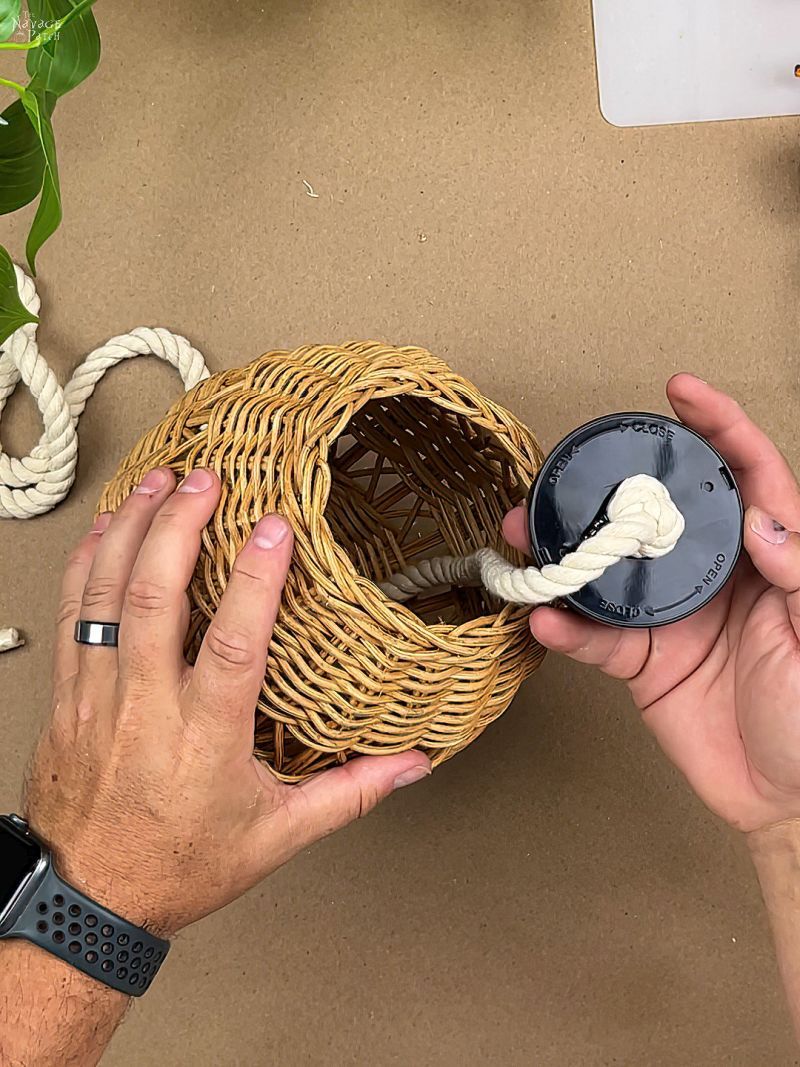 man gluing a rope to a puck light