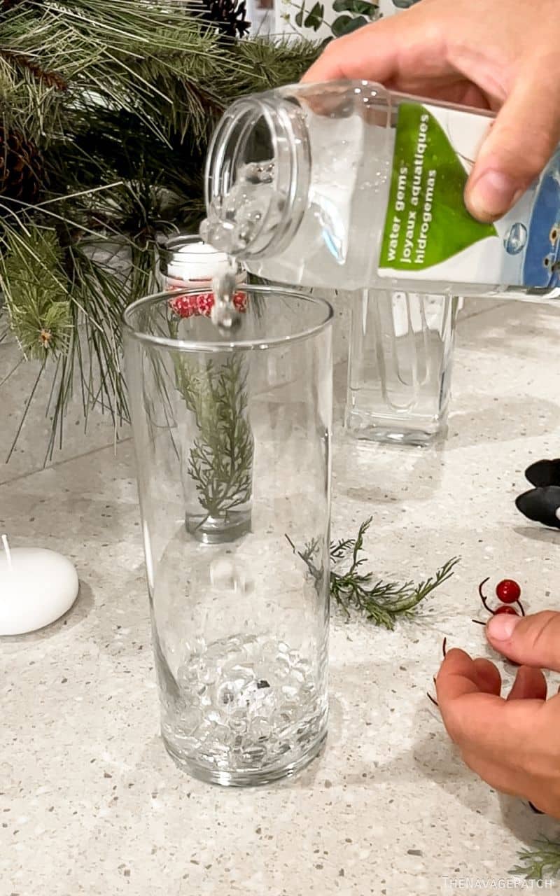 man pouring water gems into a vase