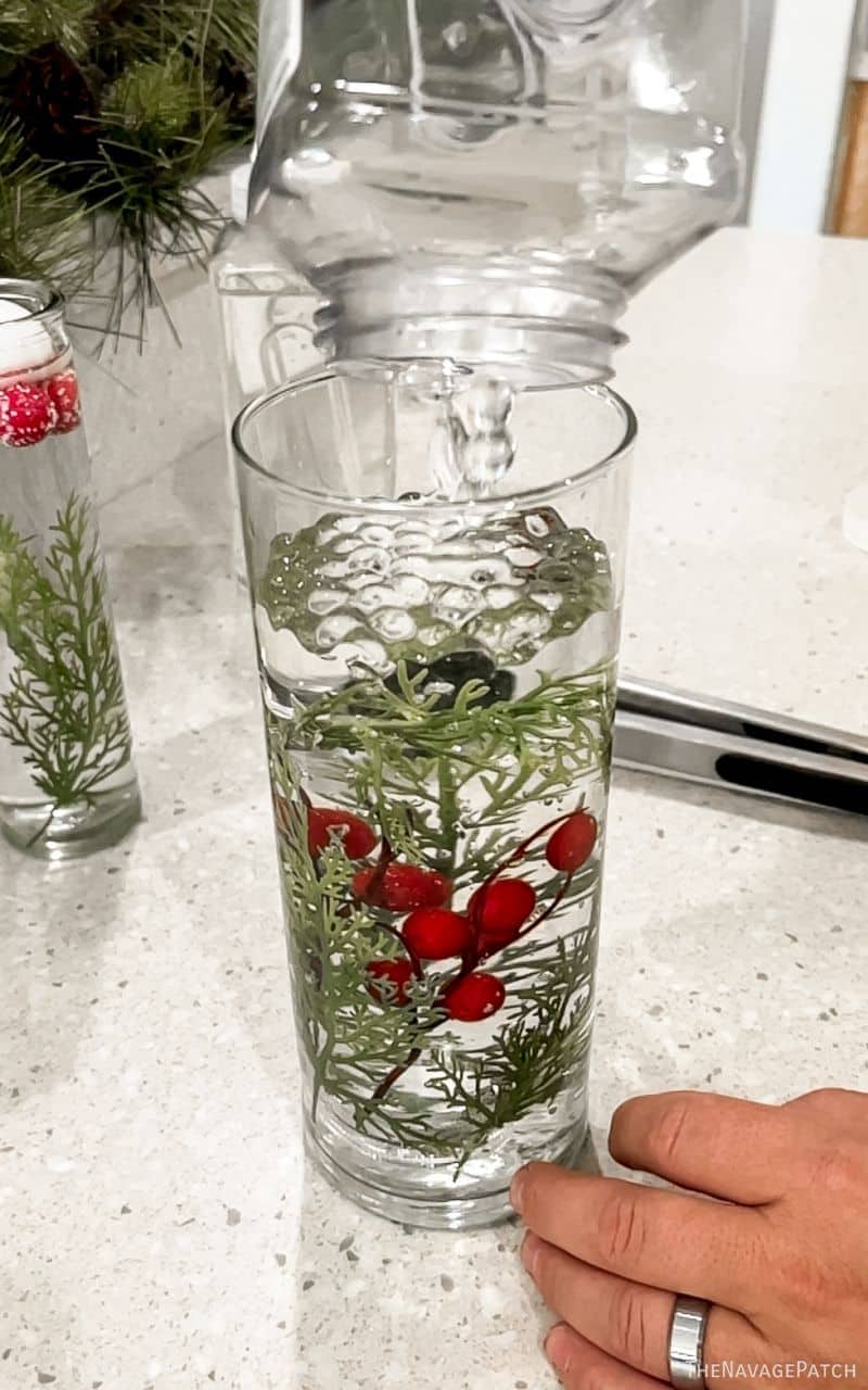 man adding greens to a vase