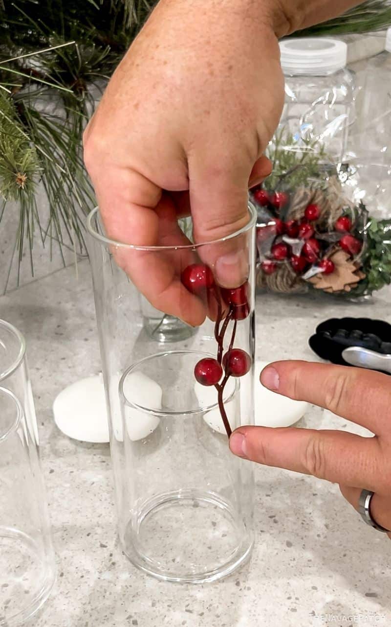 man putting berries in a vase