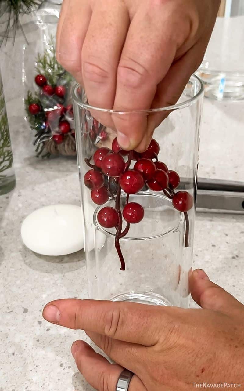 man putting berries in a vase