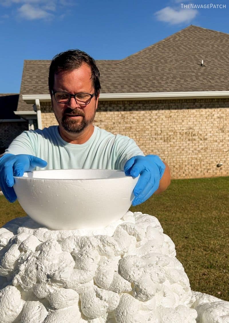 man making a foam snowman head