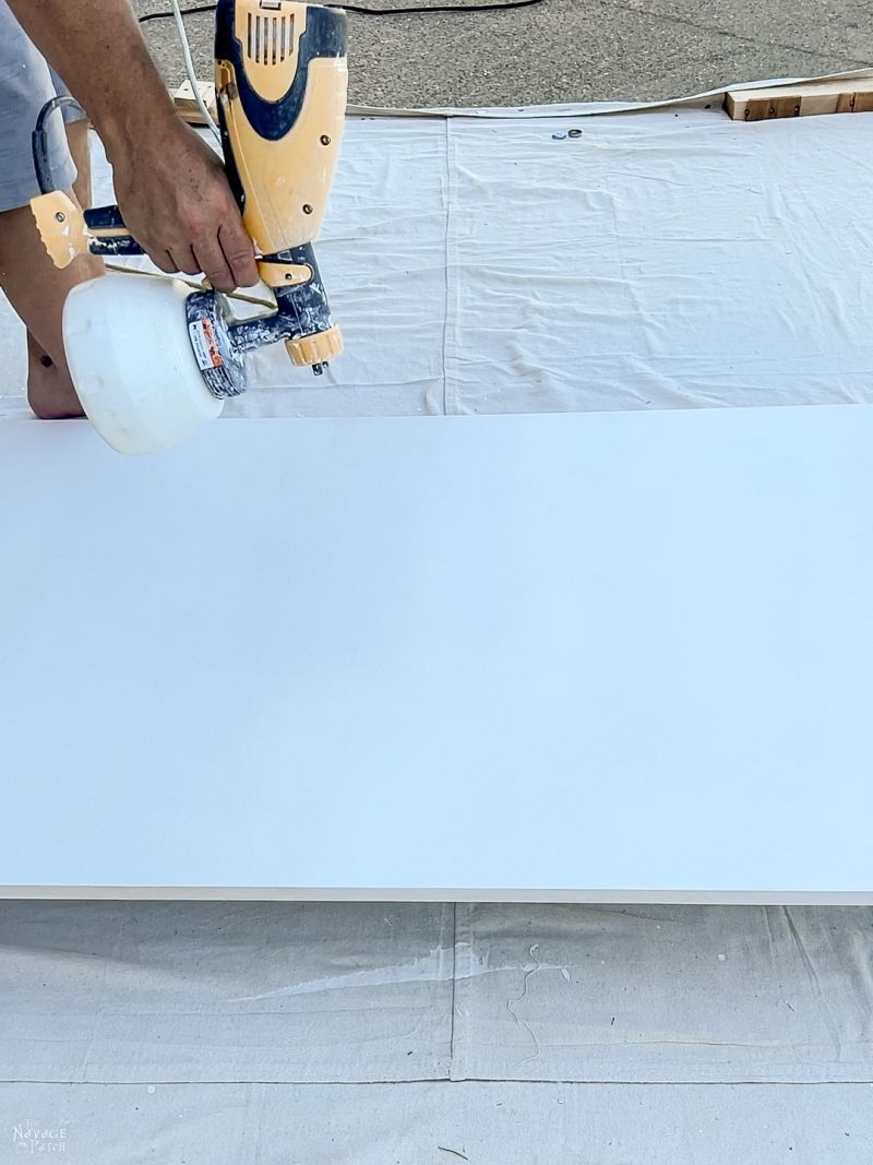 man painting a diy sliding barn door