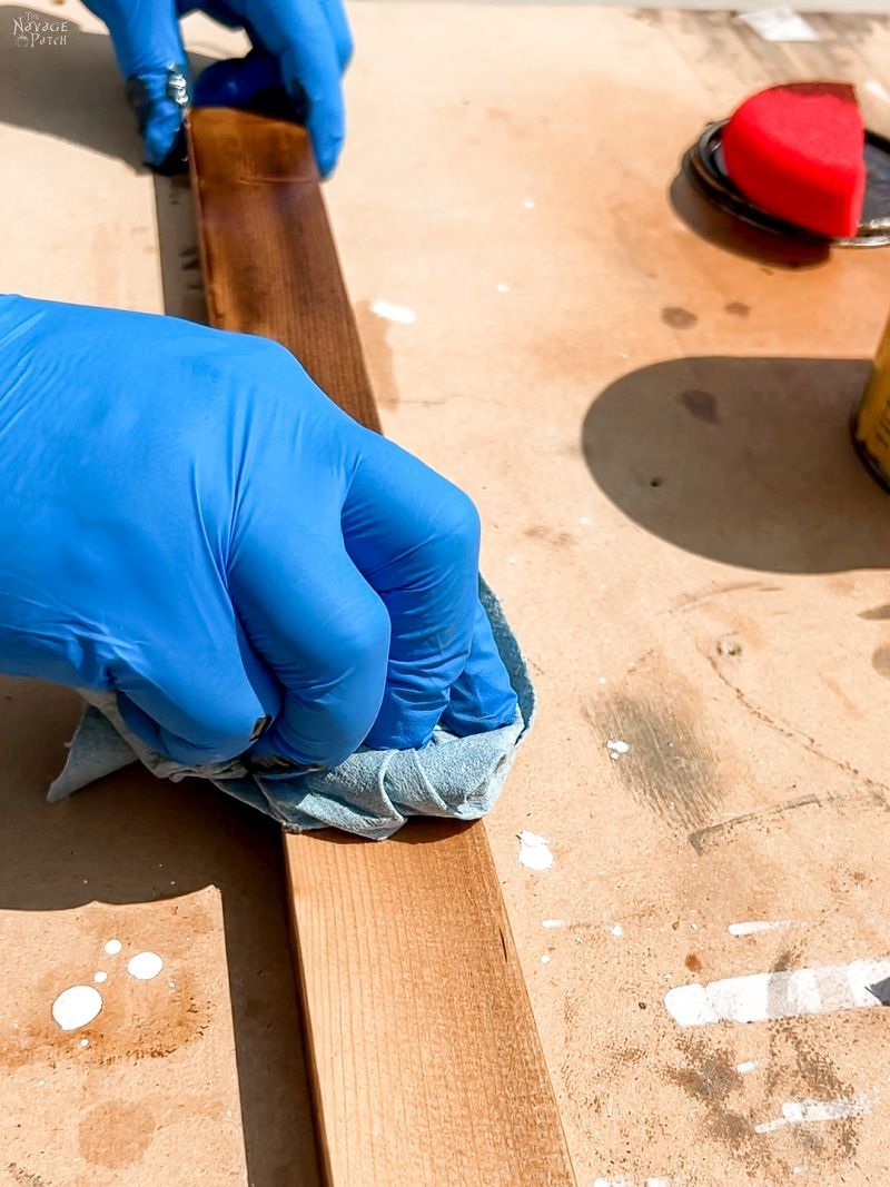 man staining pine boards