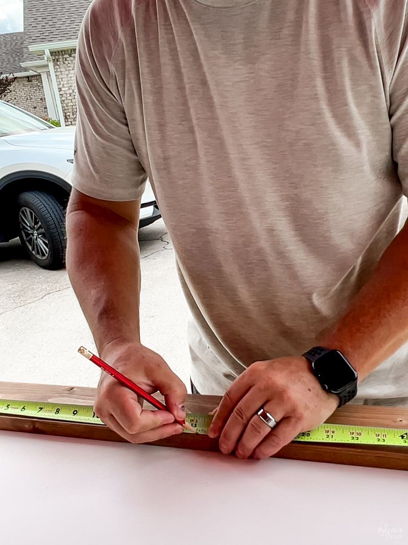 man measuring for a diy sliding modern barn door