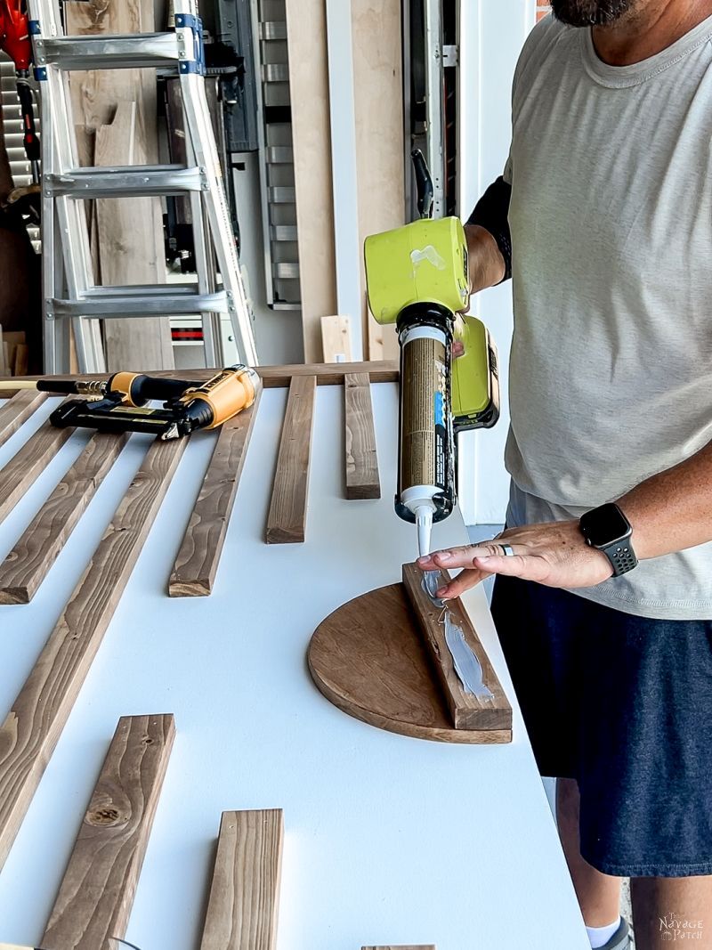 man putting glue on door pulls as hw how how to build a sliding barn door