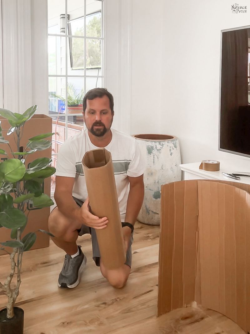 man holding cardboard cylinder