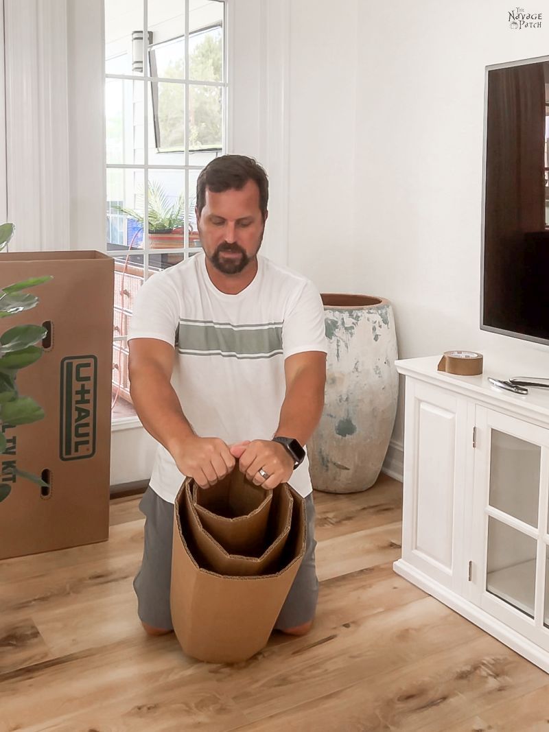 man holding cardboard cylinders