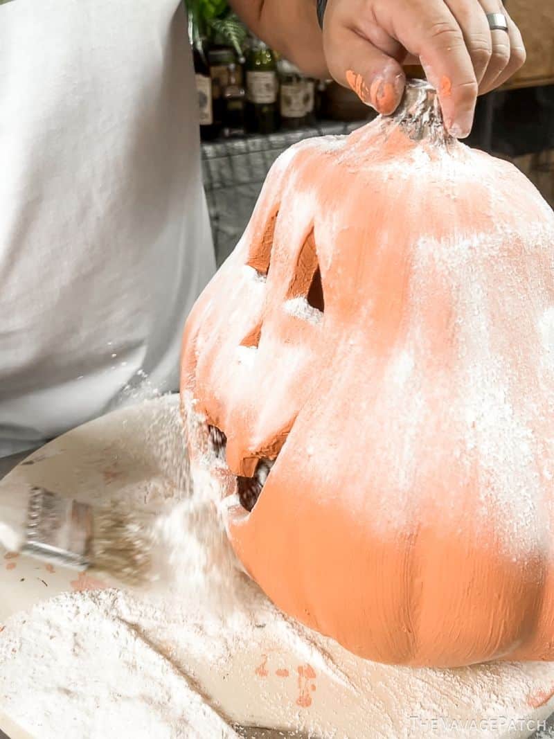 man flouring a pumpkin