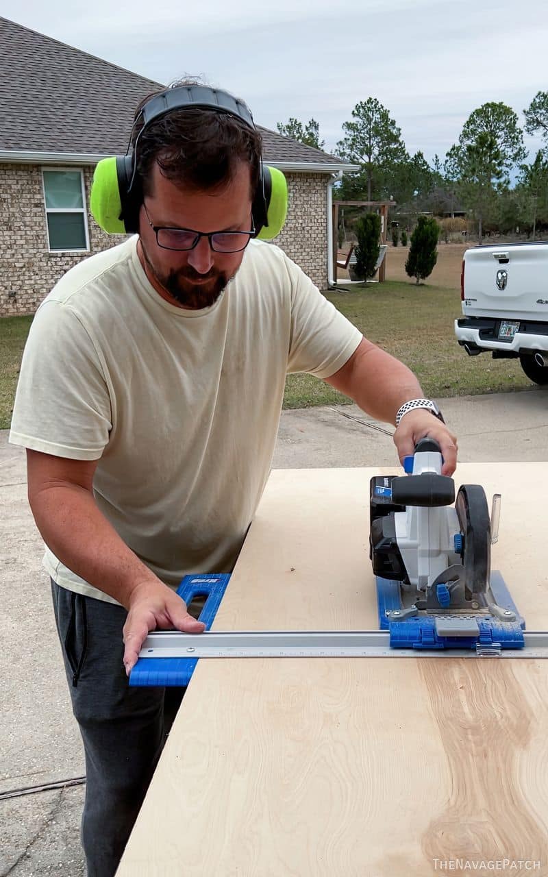 man cutting plywood