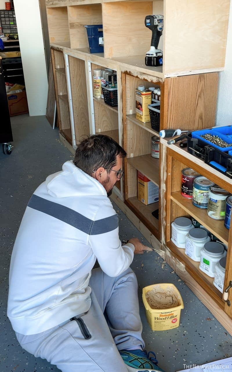 man preparing cabinets for painting