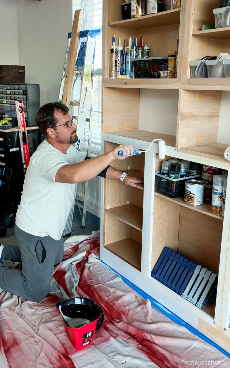 man painting cabinets