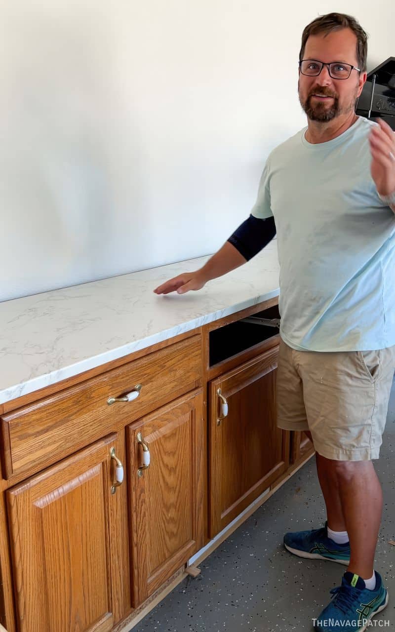 man installing cabinets in a garage